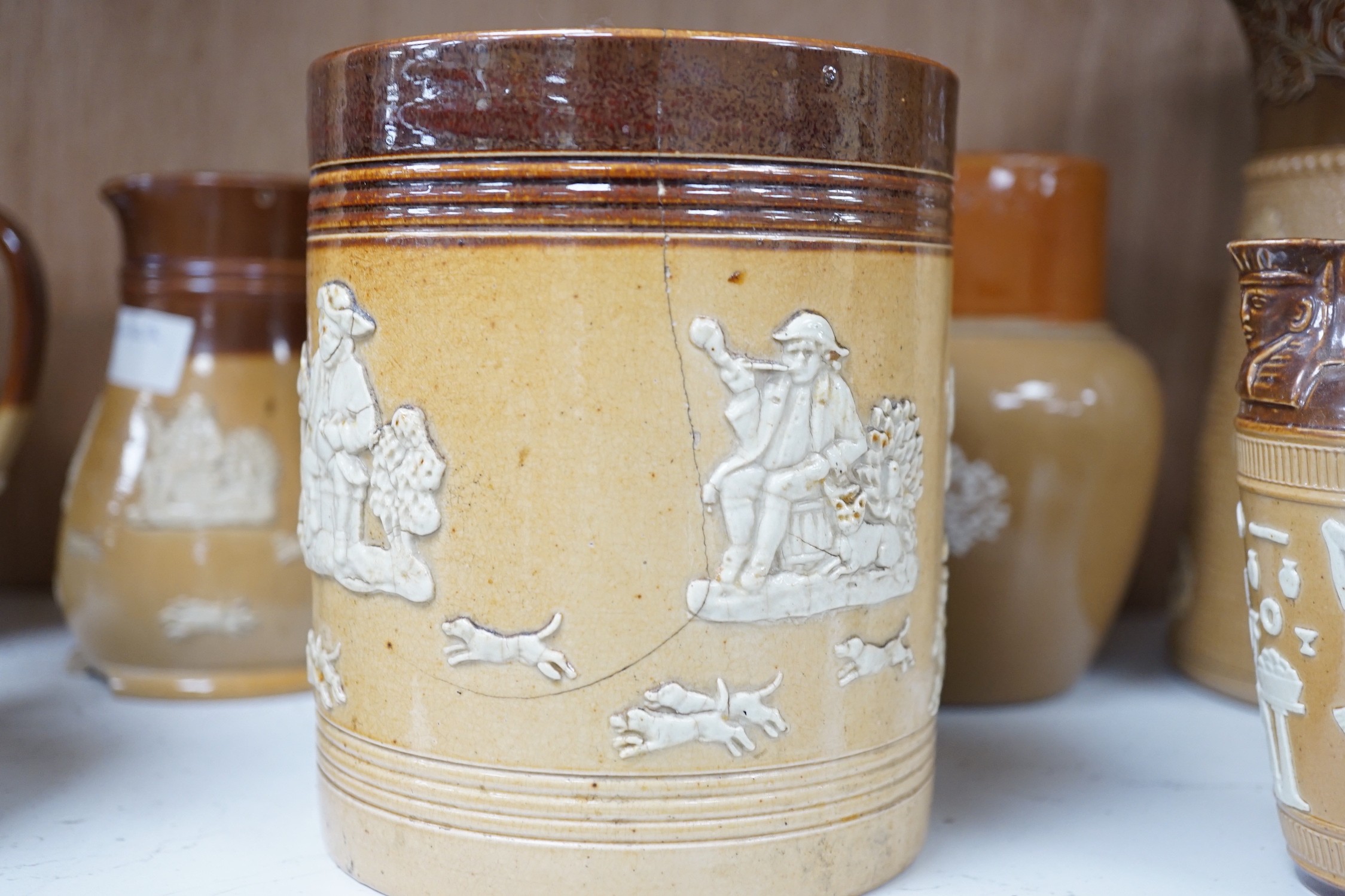 A group of Doulton stoneware jugs, storage jar, beakers, bowls etc